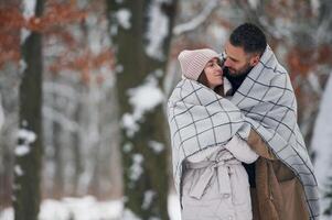 Looking at each other... Lovely ,couple, have a walk in the winter forest photo