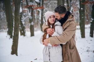 Conception, of love. Couple have a walk in the winter forest photo