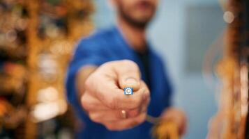 Close up view of man hand that is holding internet cable photo
