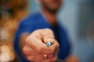 Close up, view of man hand that is holding internet cable photo