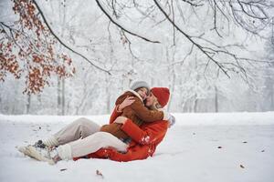 Embracing each, other. Mother ,and her ,daughter is on the winter meadow and forest photo