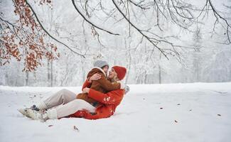 Embracing each ,,other. Mother and her daughter is on the winter meadow and forest photo