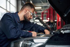 Car, repairman is in, the garage with automobile photo