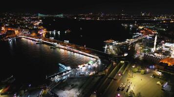 Aerial half-circle above Galata Bridge and Istanbul's illuminated coast video