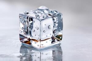 Perfectly shaped ice cube melting on reflective surface with water drops photo