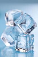 Ice cubes stacked on a blue surface creating a refreshing and cool atmosphere ideal for beverages and summer drinks healthy lifestyle concept photo