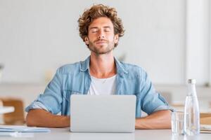 Emote worker enjoying a mid-day break while relaxing at a desk with a laptop, promoting productivity and well-being in a modern workspace, wellness concept photo