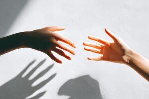 Reaching hands creating an emotional connection symbolizing unity, support, and compassion in a serene setting showcasing human interaction concept photo
