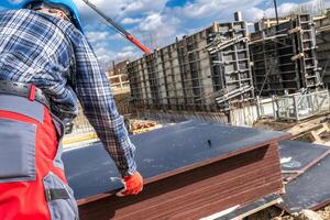Construction Worker Handling Materials at a Building Site in Spring photo