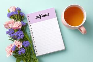 Self-care notebook with flowers and a cup of tea on a pastel background, promoting relaxation and mindfulness in daily routines, self-care concept photo