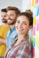 Startup coworkers smiling and looking satisfied during a brainstorming session photo
