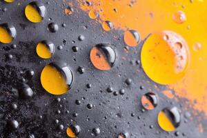 Oil and grease mixing on mechanical surface, creating abstract pattern photo