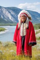 Indigenous Chief Wearing Traditional Headdress Standing in Yukon Territory photo