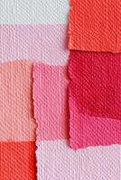 Abstract textured background with torn overlapping pink and red paper stripes creating geometric pattern photo