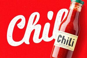 Chili sauce bottle with retro label on red background with large chili lettering photo