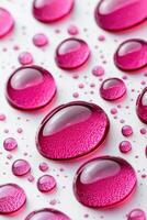 Vibrant fuchsia water drops creating a beautiful pattern on a textured surface photo