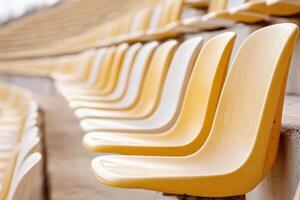 Empty yellow and white stadium seats creating a pattern photo