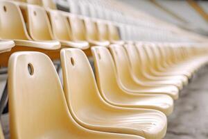 Rows of empty yellow stadium seats creating a vanishing point photo