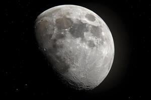 Gibbous moon glowing in the night sky, illuminating the landscape with a soft light. photo