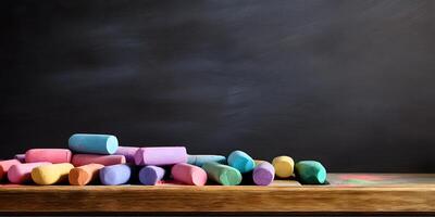 Neat black chalkboard displaying colorful chalk sticks lined up at the base for educational expression and creativity photo