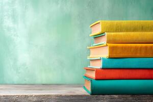 Stack of colorful books neatly arranged on a wooden shelf photo