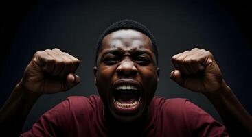 Emotionally charged moment captured in a dark setting showcasing a young man expressing intense feelings photo