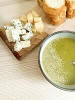 Delicious bread and cheese platter with olive oil and sesame seeds at a rustic table photo