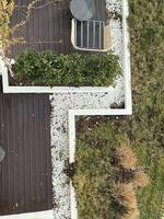 Modern outdoor landscape design featuring greenery and seating in a contemporary setting photo