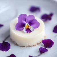 Smooth Textures and Glossy Finish. Floral Cakes. Cake with violet pansy flowers on a white background. Selective focus photo