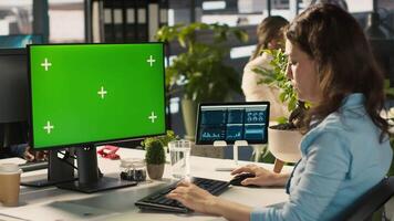 Green screen PC in office used by employee working on company administrative tasks. Mockup computer display on desk used by worker reviewing business data metrics, camera A video