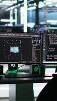 Monitors in data center displaying node tree programming optimizing infrastructure health. Visual programming systems on workstations detecting server room equipment malfunctions video