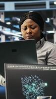 Data center computer scientists use node tree programming to identify equipment performance issues. Server farm employees review data analysis graphs to minimize infrastructure failures, camera B video