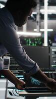 Server hub team leader and worker using node tree software to optimize system health. Data center manager supervising IT expert analyzing infrastructure issues using AI visualization, camera B video