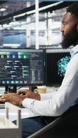 Vertical Server hub admin using AI neural network node tree program to optimize system health. Data center IT professional analyzing equipment issues using deep learning AI visualization, camera A video