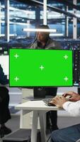 Vertical Data center IT expert uses isolated screen PC to apply deep learning node tree tech analyzing datasets. Server hub engineer uses visual programming on chroma key PC to identify data patterns, camera A video