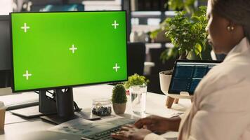 Green screen PC used by employee preparing for business meeting. Close up of mockup computer used by african american worker doing research analysis for startup organization, camera A video