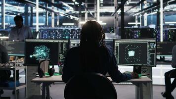 Data center engineer implements AI virtualization frameworks to optimize server clusters. Server hub IT professional doing artificial intelligence predictive analysis, camera A video
