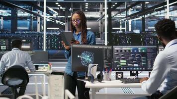 Server farm engineering team using AI algorithms and node tree systems to categorize unstructured data. Data center IT experts use visual programming and natural language processing software, camera A video