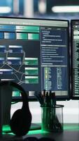 Monitors in data center displaying node tree interfaces monitoring infrastructure health. Visual programming systems on workstations helping identify malfunctions in server room equipment, closeup video