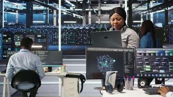 Cheerful data center employee using node tree software to analyze datasets. Upbeat server facility engineer using visual programming to improve infrastructure performance, camera A video