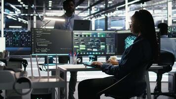 Server farm manager supervising engineer using node tree systems to categorize unstructured data. Data center supervisor overseeing IT expert using natural language processing software, camera A video