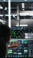Vertical Server hub engineering team working together, using node tree software to optimize system health. Data center teamworking colleagues brainstorming equipment issues using AI visualization, camera B video