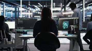 Vertical Stressed server hub admin worried by malfunctioning data analytics AI generator. Anxious data center worker concerned by critical error in artificial intelligence tool showing system metrics, camera A video