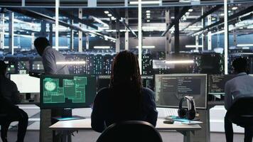 Vertical Cybersecurity team in data center responds to security breach, trying to prevent unauthorized access. Workers rushing to secure servers and protect sensitive information during cyberattack, camera A video