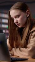 Vertical University student does research on foreign affairs via primary source materials and academic resources to create an assignment. Girl working hard for a scholarship and diploma. Camera A. video
