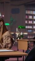 Vertical Confident student gathers information and citations from reliable sources via massive database at university library, working on bachelor degree paper. Intelligent girl studies. Camera A. video