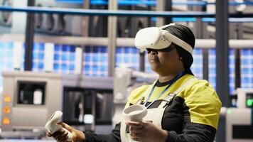 Photovoltaics smart factory expert using VR tech to manage automation systems. Solar panels industry 4.0 plant technician using virtual reality gear to evaluate equipment, camera B video