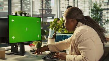 Green screen PC used by employee preparing for business meeting. Close up of mockup computer used by african american worker doing research analysis for startup organization, camera B video
