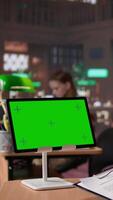Vertical University scholar writes project ideas next to green screen on tablet, gathering citations from reliable books and other sources at the library. Girl consulting the educational materials. Camera B. video