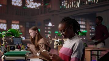 African american girl reading and taking notes for exam at the college, studying political science for upcoming class lesson in a library at university. Young student consults textbooks. Camera B. video